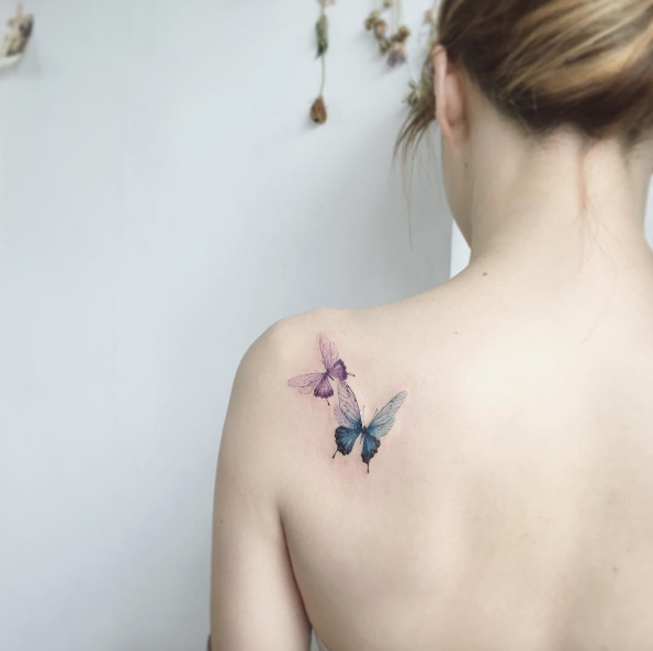 Butterflies on back shoulder by Tattooist Flower
