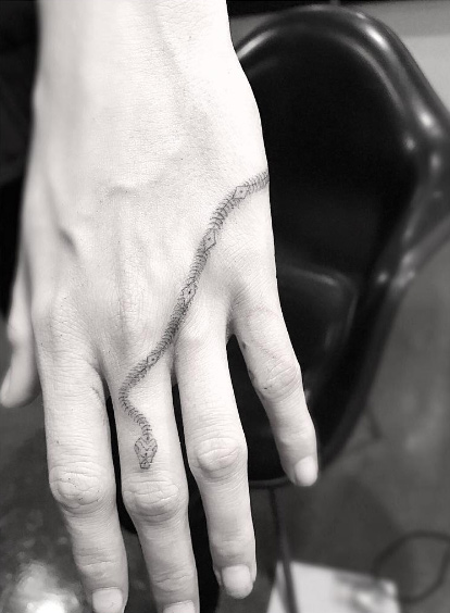 Cara Delevingne's snake tattoo by Doctor Woo