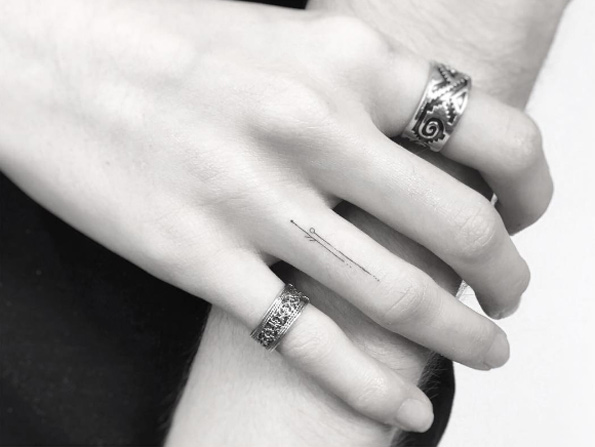 Fine line finger tattoo by Jakub Nowicz