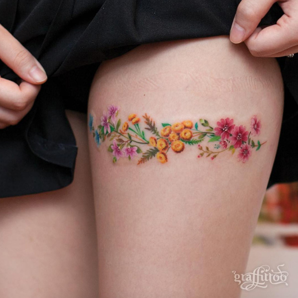 Floral thigh tattoo by Tattooist River