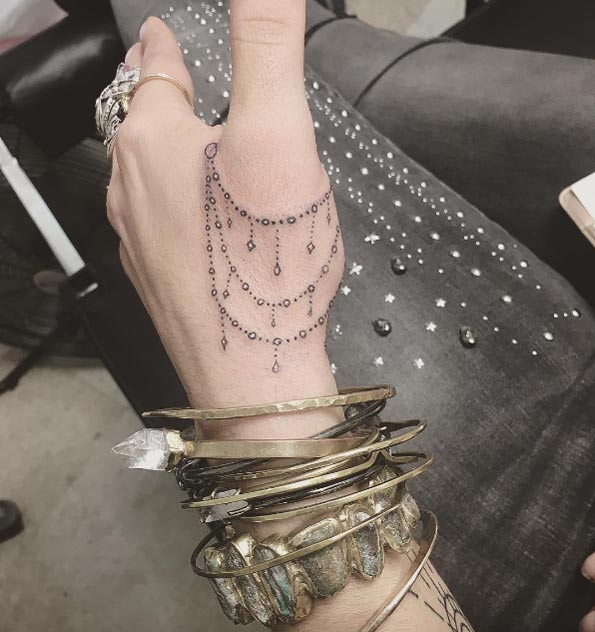 Jewelry tattoo on hand by Kayleigh Kerr