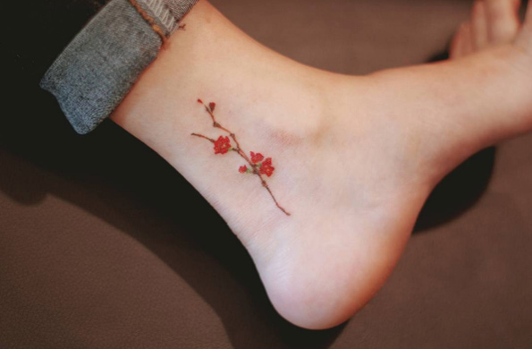 Tiny floral branch tattoo by Seoeon