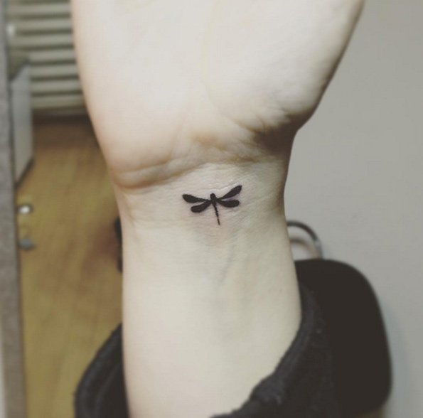 Cute dragonfly tattoo on wrist by Caglar