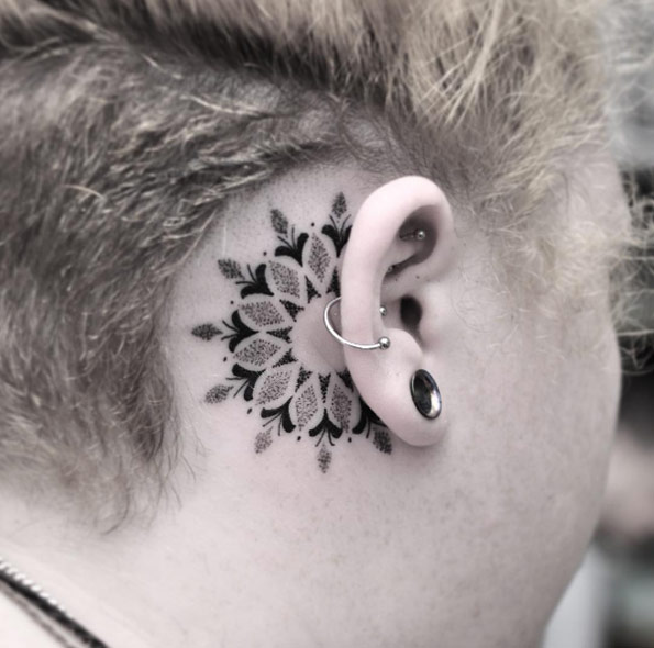 Behind-the-ear mandala flower tattoo by Chris Jones