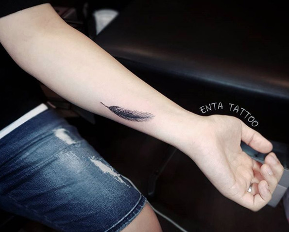 Feather on wrist by Enta