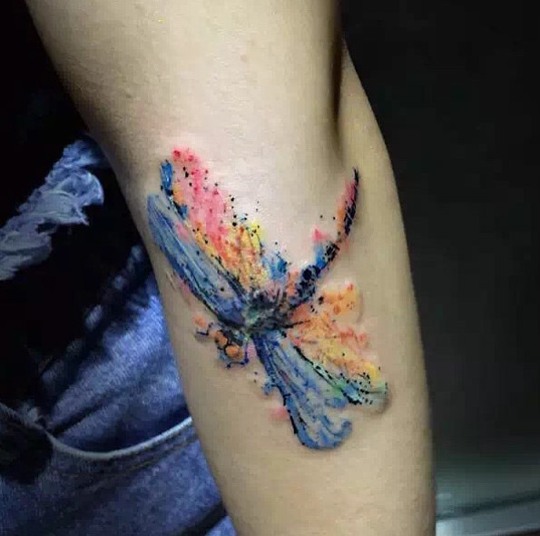 Colorful abstract dragonfly tattoo by Wang Lei