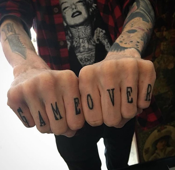 'Game over' knuckle tattoos by Aidan Rouse