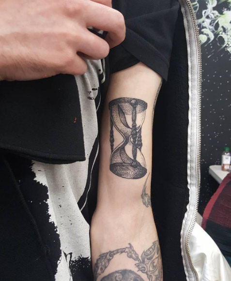 Hourglass tattoo on bicep by V R. Rivera