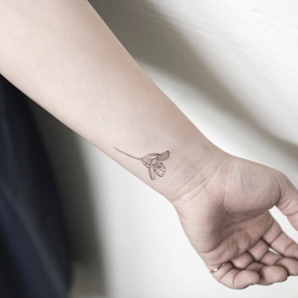 Tiny flower tattoo on wrist by Hongdam