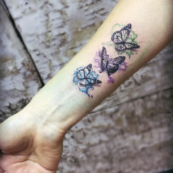 Watercolor butterflies on wrist by Charl Richardson