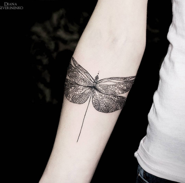 Dragonfly tattoo on forearm by Diana Severinenko
