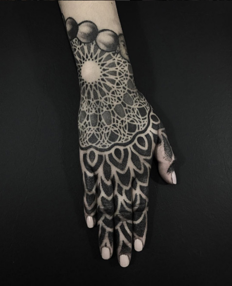 Mandala flower tattoo on hand by Eric Stricker