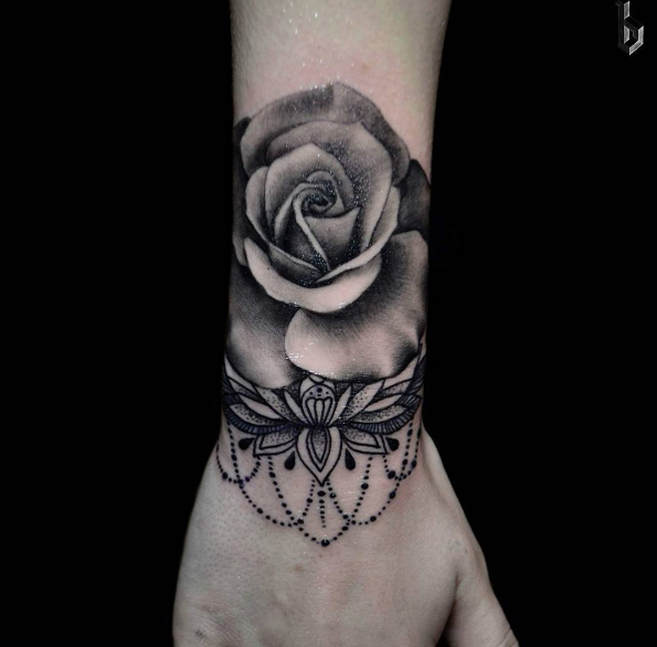 Blackwork rose tattoo on wrist by Benji 