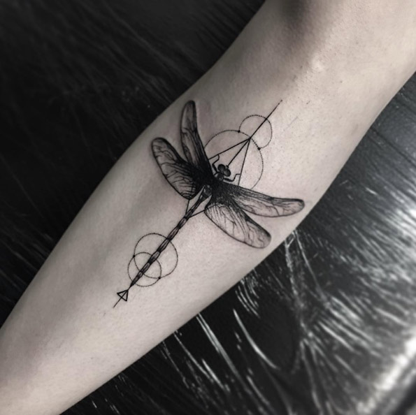 Blackwork dragonfly tattoo on shin by Sara Reichardt