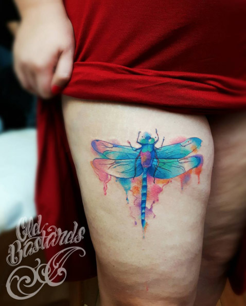 Watercolor dragonfly tattoo on thigh by Simina