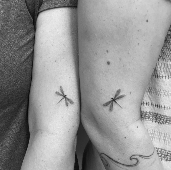 Matching dragonfly couple tattoos by Carla Galvao