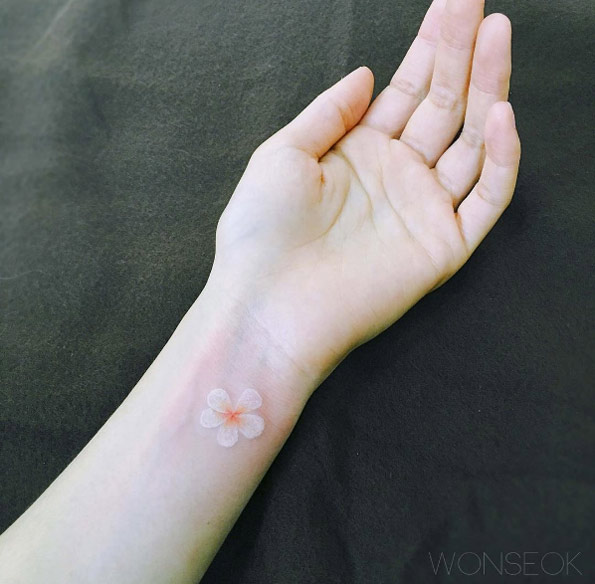 White ink blossom on wrist by Wonseok
