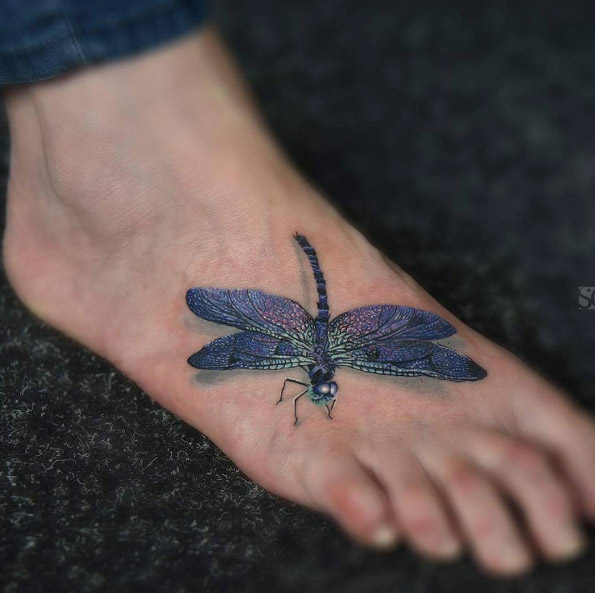 Beautiful dragonfly tattoo on foot by Catalin Druga
