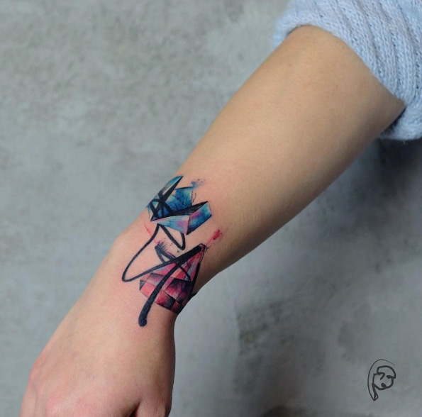 Fun abstract watercolor wrist tattoo by Tayfun Bezgin