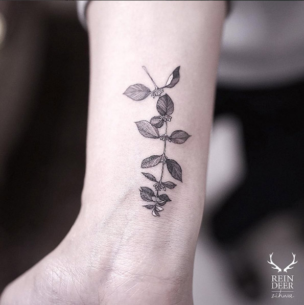 Black and white ink branch on wrist by Zihwa