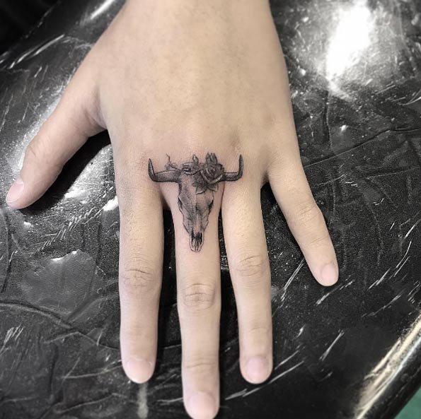 Steer skull knuckle tattoo by Isaiah Negrete