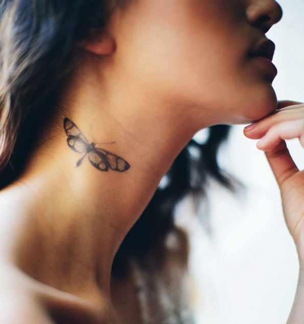 Dragonfly tattoo on neck