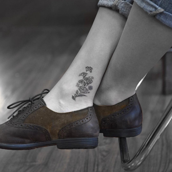 Blackwork bouquet on ankle by Evan