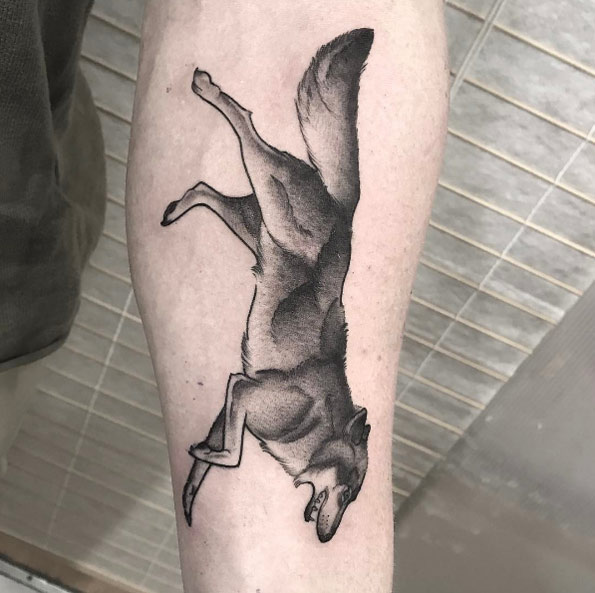 Running wolf tattoo by Ash Timlin