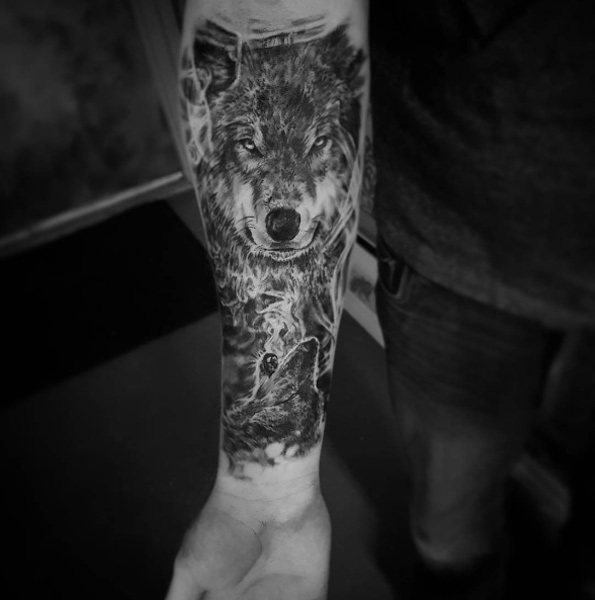 Smokey wolf tattoo on forearm by Odalisque Studios
