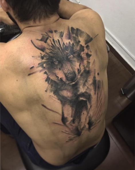 Watercolor wolf tattoo on back by Zanotto