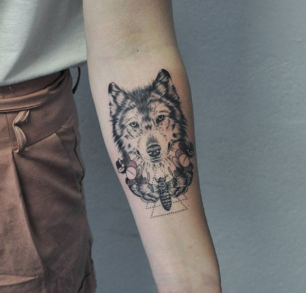 Wolf tattoo on forearm by Wolf & Wren