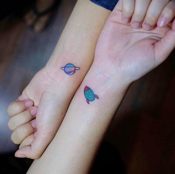 Cute space-themed friendship tattoos
