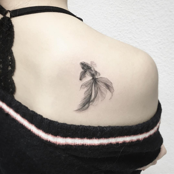 Elegant goldfish tattoo by Tattooist Flower
