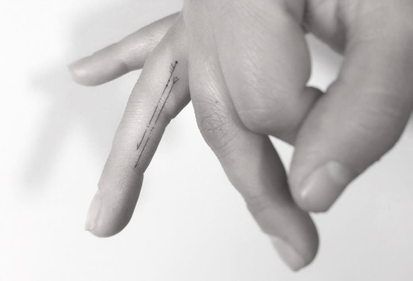 Tiny arrow finger tattoos by Jakub Nowicz