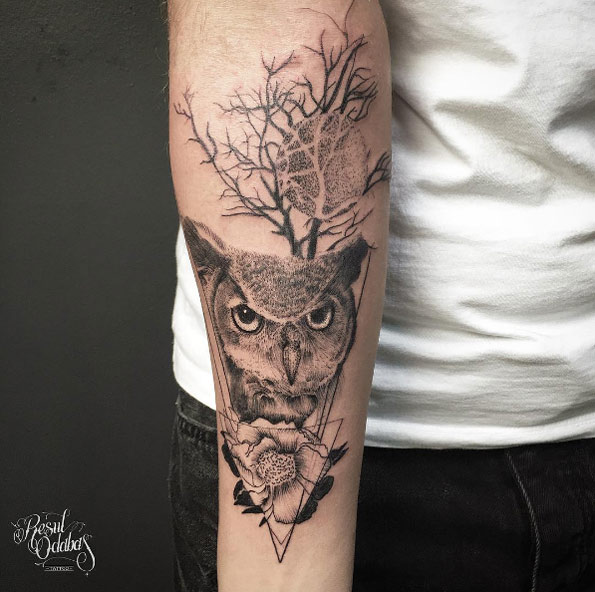 Stunning owl tattoo on forearm by Resul Odabas