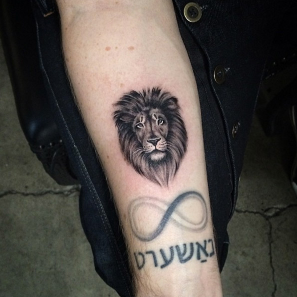Small lion tattoo on forearm by Elisabeth Markov