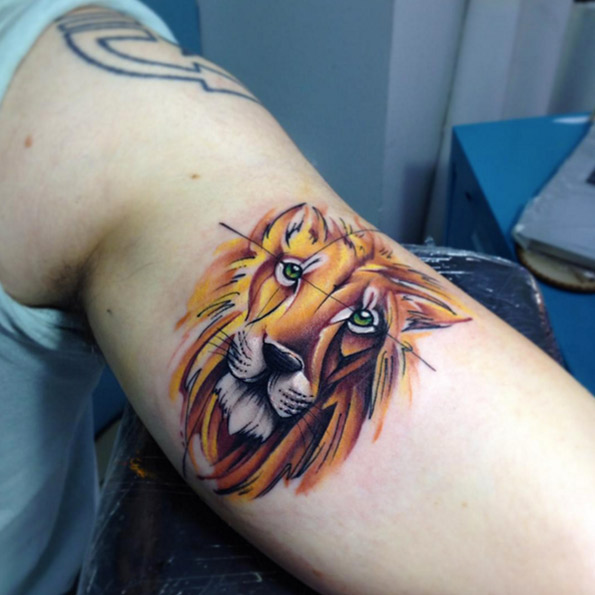 Bicep lion tattoo by Adrian Bascur