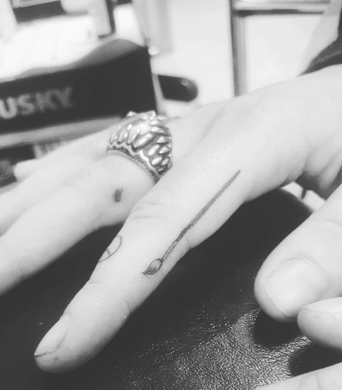 Paintbrush tattoo on finger by Daniel Marmo