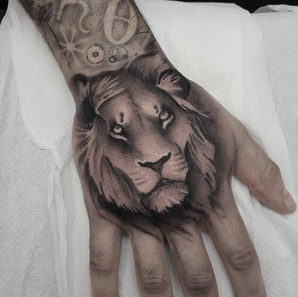 Lion tattoo on hand by Vik B