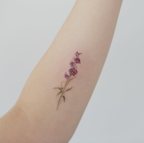 Small watercolor flower by Tattooist Doy
