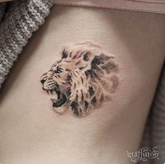 Lion tattoo with negative space mane by Tattooist River