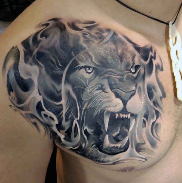 Lion on fire tattoo by Piotr Deadi Dedel