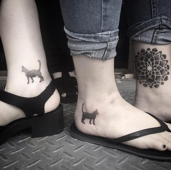 Matching dotwork cat tattoos by Saskia Viney