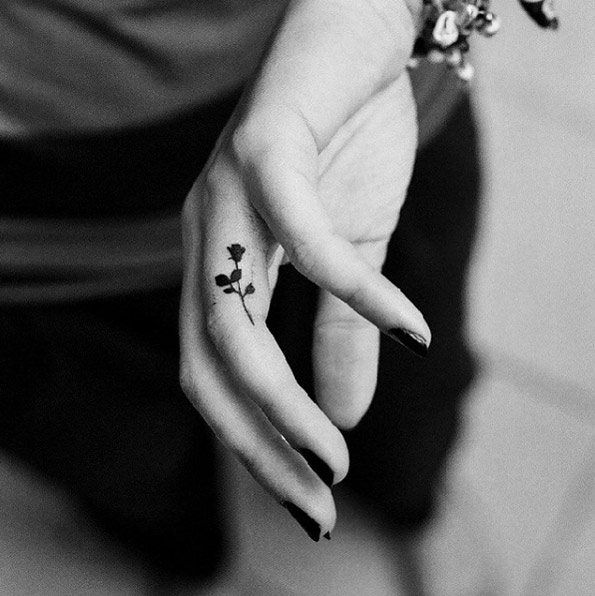 Blackwork rose tattoo on finger by Tusz Za Rogiem