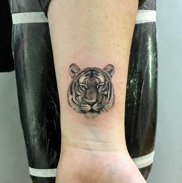 Tiger wrist tattoo by Bradley Conradie