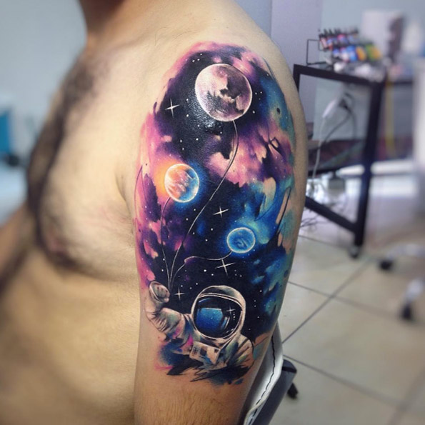Epic upper arm space tattoo by Adrian Bascur