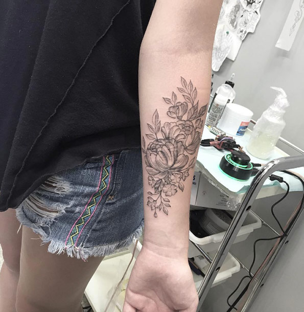 Peony scar-concealing tattoo on forearm by Bonnie