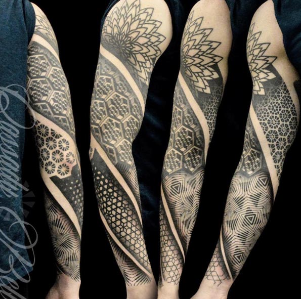 Spiraling full sleeve tattoo by Cassady Bell