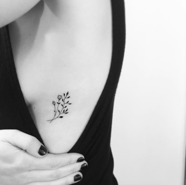 Delicate botanical piece on rib cage by OK