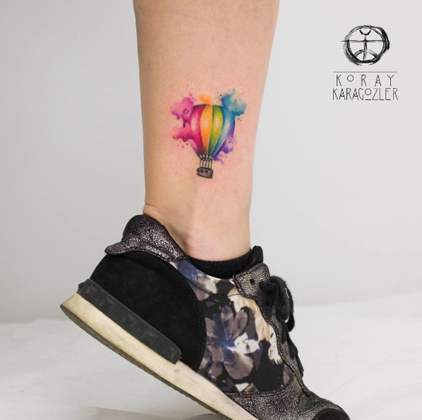 Watercolor hot air balloon tattoo by Koray Karagozler